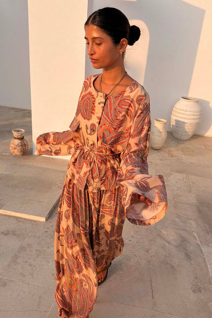 Peach Paisley Anna Top with a tie waist and long sleeves, styled as a co-ord with matching balloon trousers.