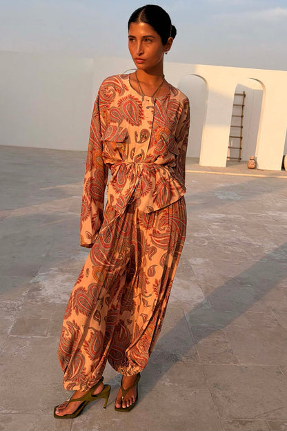 Peach Paisley Balloon Trousers and matching co-ord top with classic motifs in a sunlit outdoor setting.