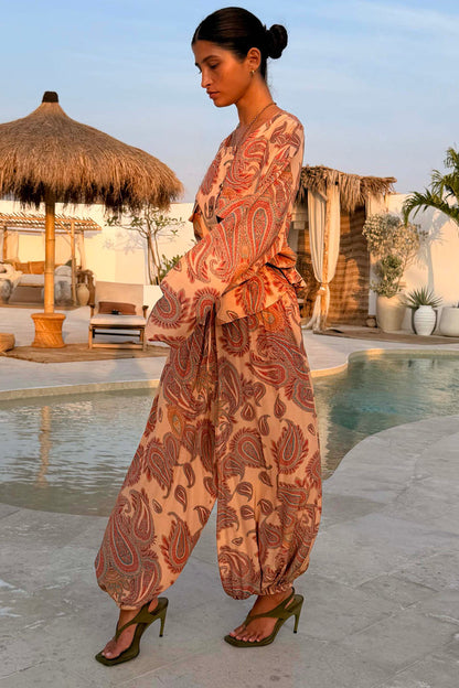 Peach Paisley Balloon Trousers and matching top styled as a co-ord in a poolside vacation setting.