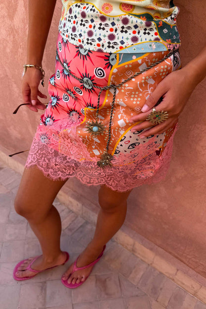 Pastel Morocco Mini Maeva Skirt featuring a sun and eye print with a pink lace border.