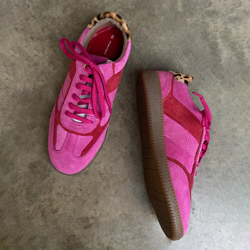 Pink and Red Leather Trainer featuring leopard print heel tabs and brown gum soles on a grey concrete floor.