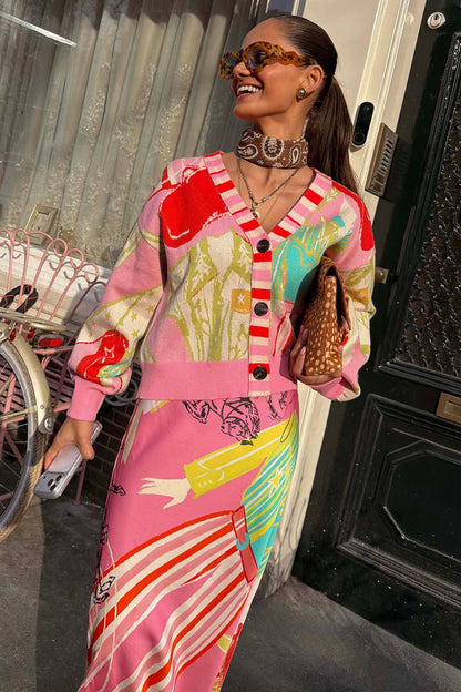 Pink Dallas Cardigan featuring abstract cowboy motifs and a striped button stand, styled with a matching patterned skirt.