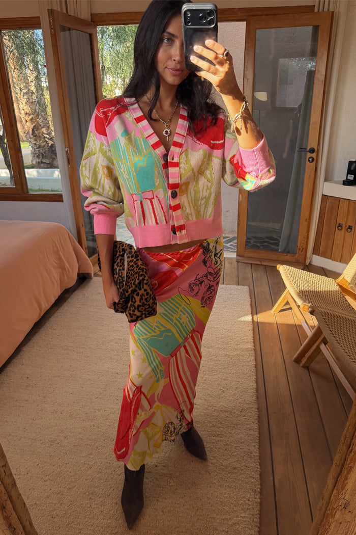 Pink Dallas Dorris Skirt in an abstract cowboy print, styled with a matching cardigan and leopard clutch.