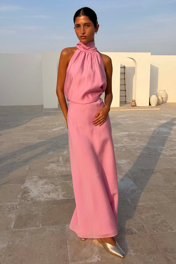 Pink Daphne Skirt with a high-waisted straight fit, styled as a co-ord for a wedding guest look in a sunny setting.
