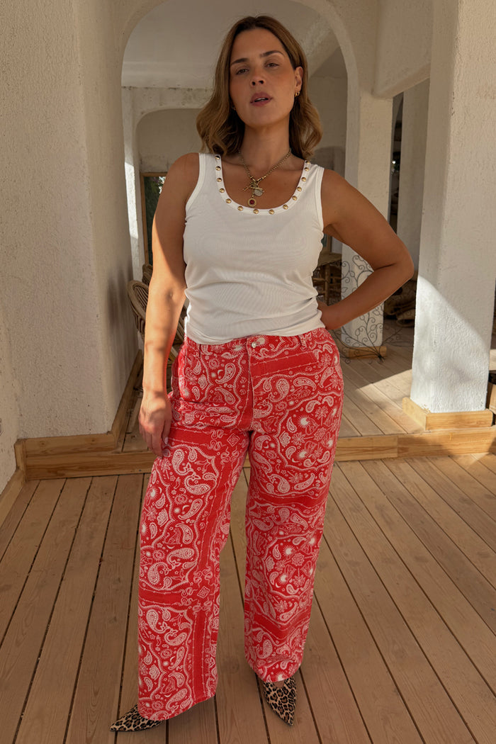 Red Bandana Jeans with a paisley print and straight leg, styled on a curve model with a white tank and leopard heels.