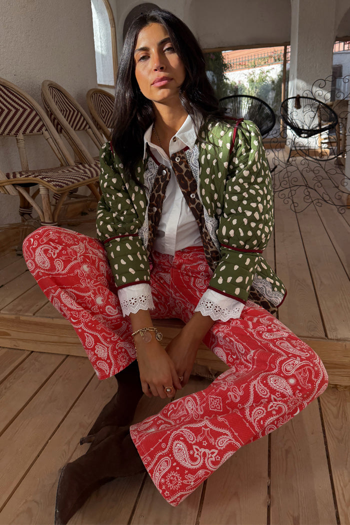 Straight leg Red Bandana Jeans in a red and white paisley print, styled with a green quilted jacket and white shirt.
