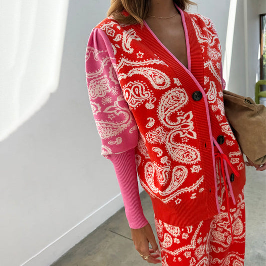 Red Bandana Martha Cardigan in a soft pink and red paisley knit with black buttons and puffed sleeves.