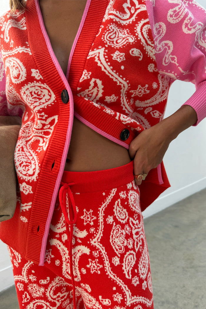 Red Bandana Martha Cardigan in a soft knit with pink trim, paired with matching red and pink joggers.