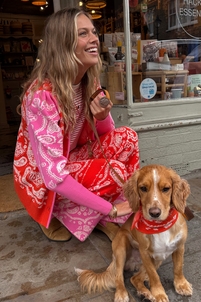 Red Bandana Martha Cardigan in pink and red knit, styled with matching joggers and a dog.