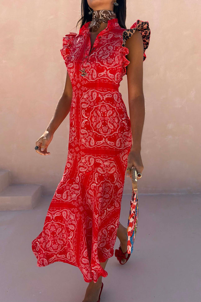 Red Bandana Remi Dress featuring leopard print ruffle sleeves and a frilled neckline in a sunny outdoor setting.