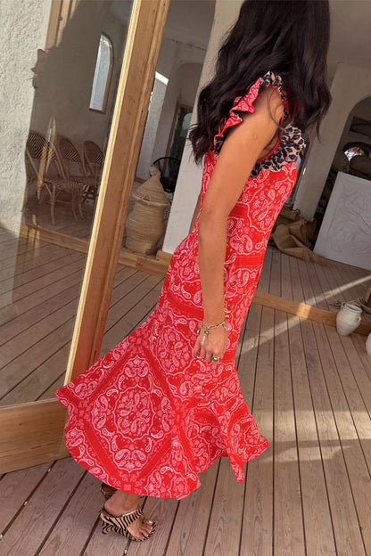 Red Bandana Remi Dress featuring leopard print frill sleeves and an asymmetrical hem on a sunlit wooden deck.