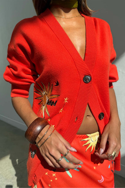 Red Celestial Cardigan featuring sun and star embroidery, button-up front, styled with the matching Dorris skirt.