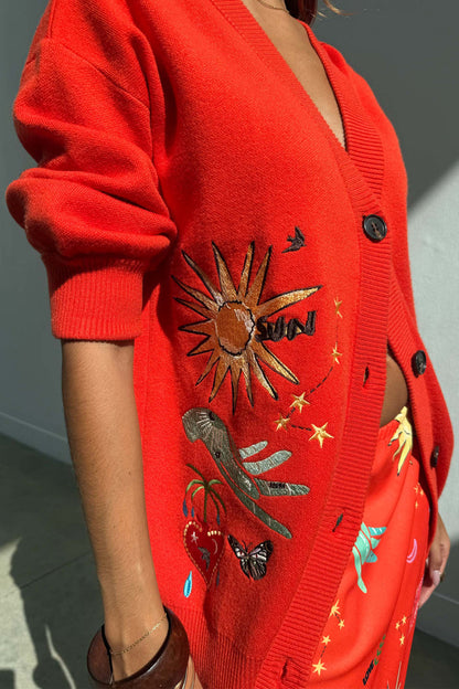 Red Celestial Cardigan featuring embroidered sun, heart and palm motifs on a soft knit with button-up front.