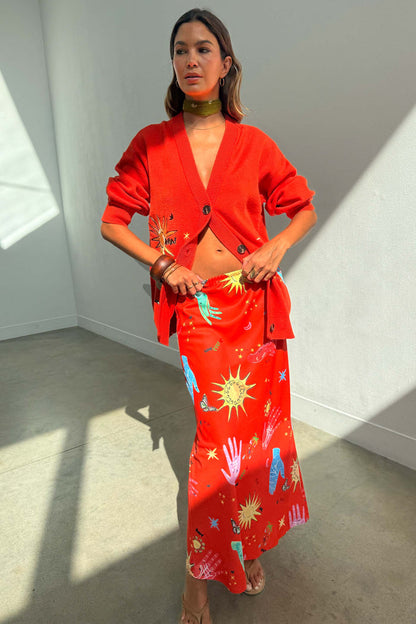 Red Celestial Cardigan in a soft knit with embroidered motifs, paired with the matching printed Dorris maxi skirt.