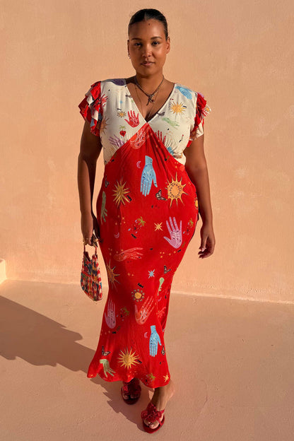 Red Celestial Midi Dress featuring sun and hand motifs, a V-neck blouson top and ruffle sleeves for curve fashion.