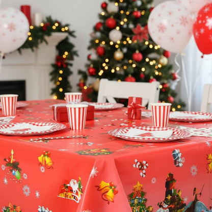 Christmas-themed table setting with red tablecloth, decorations, and balloons.