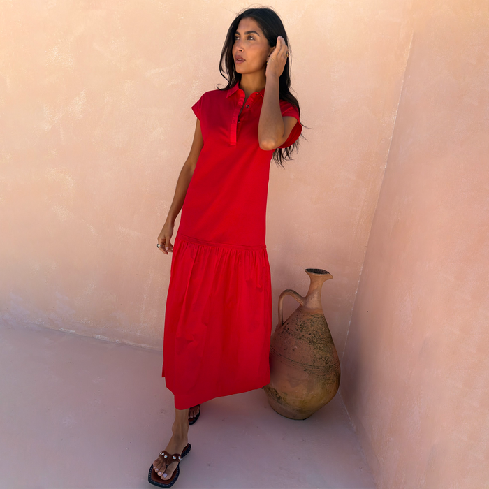 Red Darcy Cotton Midi Dress featuring a dropped waist and collared neckline, styled for a summer vacation.