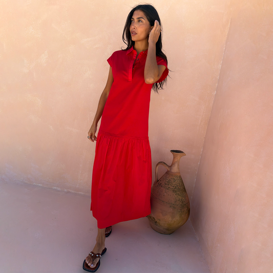 Red Darcy Cotton Midi Dress featuring a dropped waist and collared neckline, styled for a summer vacation.