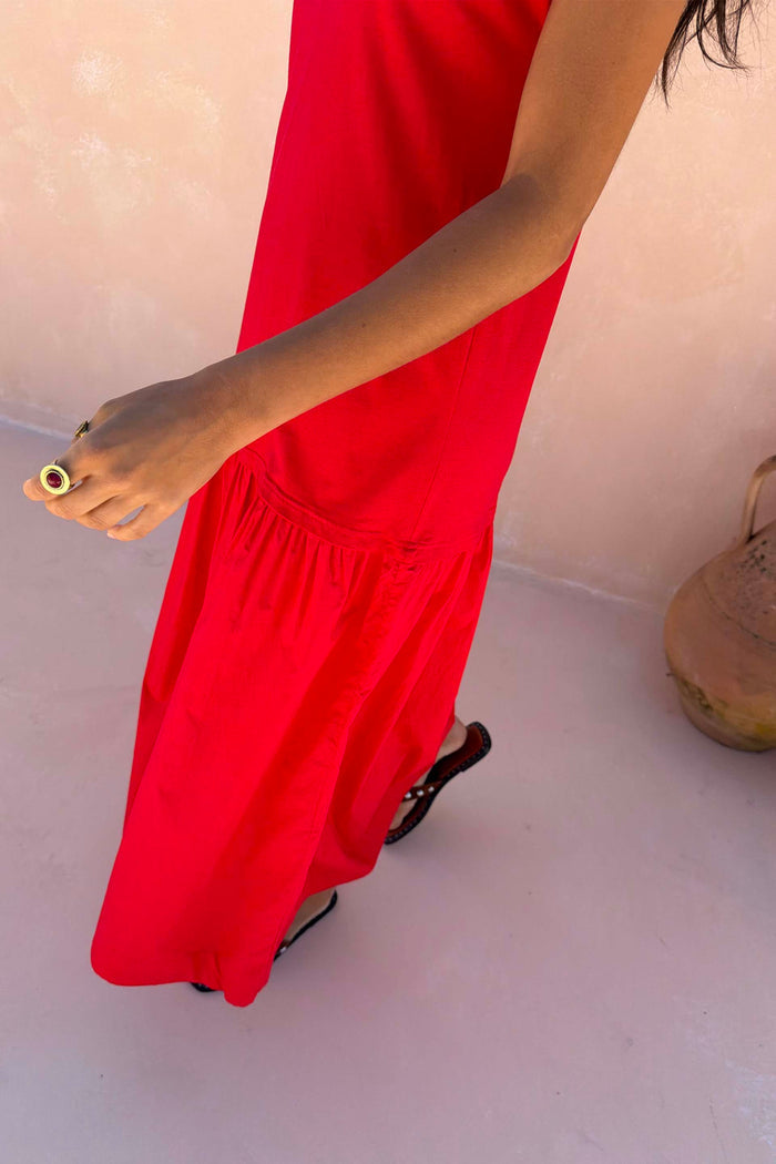 Red Darcy cotton midi dress in bright red featuring a dropped waist and lightweight fabric, designed in London.