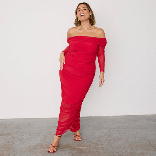 Red Diaz Dress in ruched mesh with an off-the-shoulder neckline and long sleeves on a smiling model.