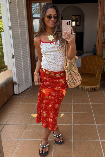 Red Floral Midi Skirt in a relaxed silhouette, styled with a floral cami and straw bag for a summer vacation look.