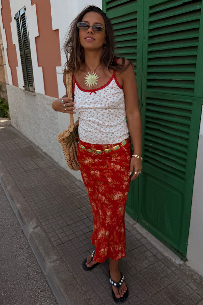 Red Floral Midi Skirt with a white blossom print and relaxed silhouette, perfect for vacation styling.