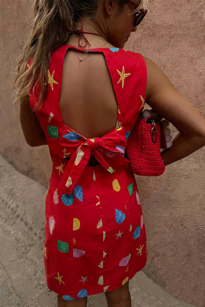 Red Shell Ioana Mini Dress in cotton-linen with a multicoloured shell print and open back tie detailing.