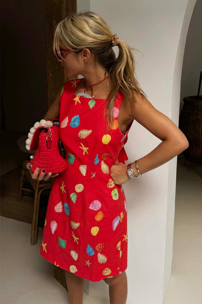 Red Shell Ioana Mini Dress with a multicoloured shell print and structured silhouette, worn by a 5ft4” model in a UK size 8.