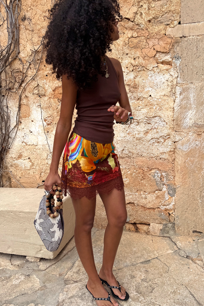 Rio Mini Maeva Skirt featuring a tropical fruit placement print and delicate brown lace trim at the hem.