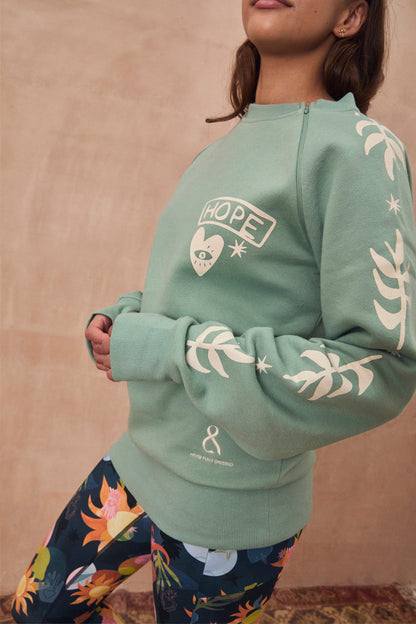 Sage Sundazed Accessible Sweatshirt with palm prints, HOPE graphic, and concealed zips for treatment access.
