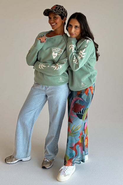 Sage Sundazed Accessible Sweatshirt with cream palm prints, HOPE graphic and concealed zips, worn by two models.