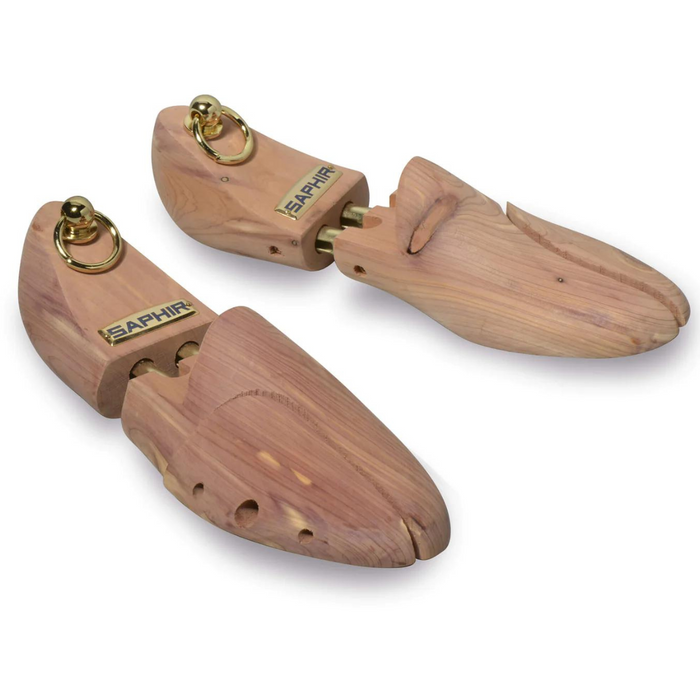 A pair of red aromatic cedar wood shoe trees with brass fittings, designed to be inserted into shoes to maintain their shape.