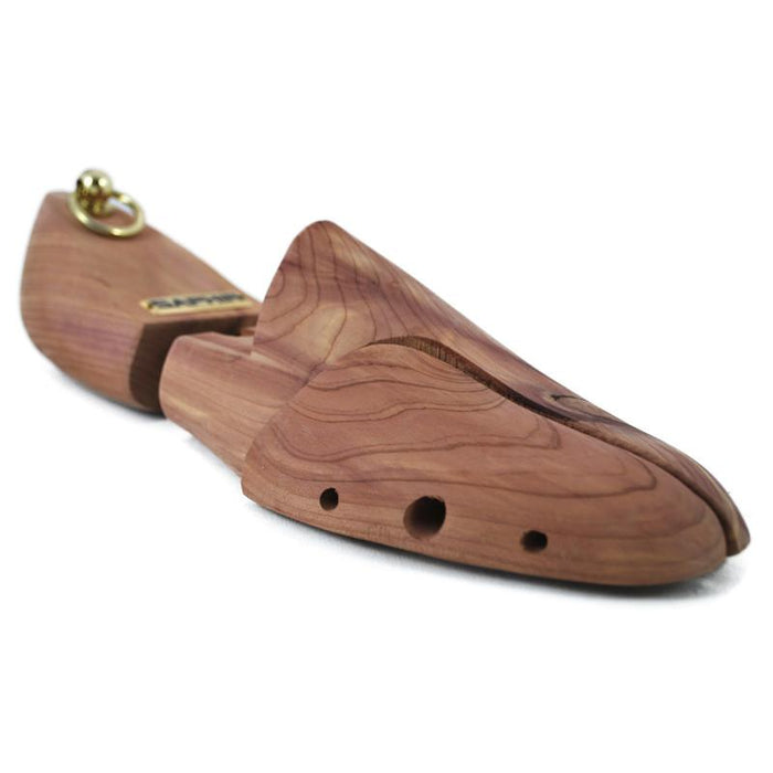 A pair of red aromatic cedar wood shoe trees with brass fittings, designed to be inserted into shoes to maintain their shape.