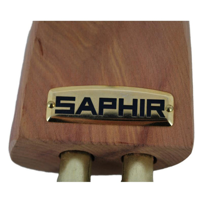 A pair of red aromatic cedar wood shoe trees with brass fittings, designed to be inserted into shoes to maintain their shape.