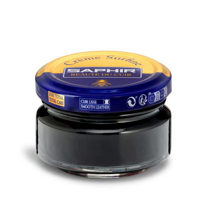 A jar of Saphir Creme Surfine shoe polish in black color with a label on the lid.
