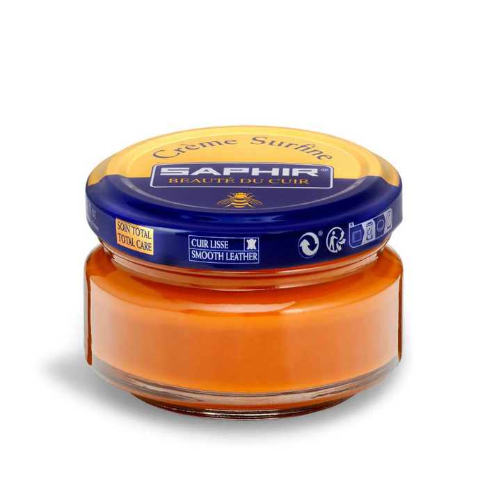 A jar of Saphir Creme Surfine shoe polish with a label on the lid.