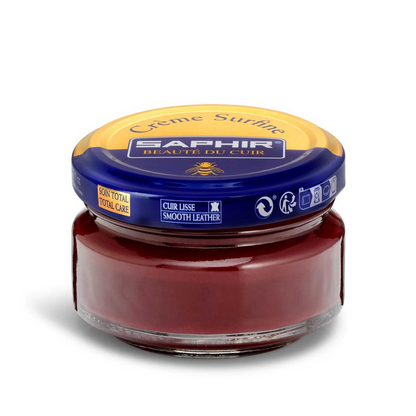 A jar of Saphir Creme Surfine shoe polish with a label on the lid.