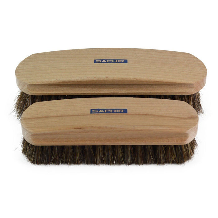 Two Saphir brand horsehair brushes with varnished beechwood handles and natural brown bristles, displayed side by side.