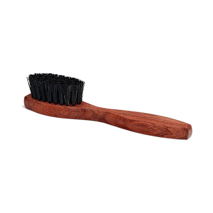 A long-handled spatula-shaped shoe polish applicator brush with black bristles and a wooden handle.