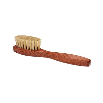 A long-handled spatula-shaped shoe polish applicator brush with natural 
bristles and a wooden handle.