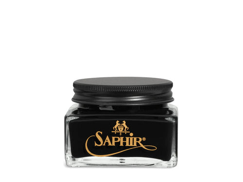 A glass jar with a black lid labeled 'SAPHIR' containing cream shoe polish.