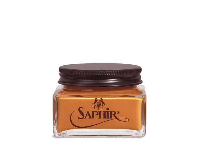 A glass jar with a black lid labeled 'SAPHIR' containing cream shoe polish.