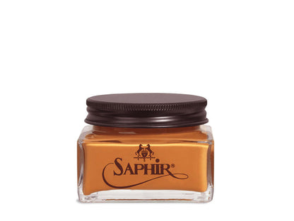 A glass jar with a black lid labeled 'SAPHIR' containing cream shoe polish.
