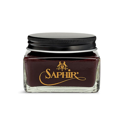 A glass jar with a black lid containing brown-colored Saphir Medaille D'Or Cordovan Cream Shoe Polish, branded with the Saphir logo on the front.