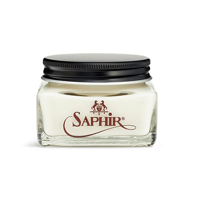 A glass jar with a black lid containing clear-colored Saphir Medaille D'Or Cordovan Cream Shoe Polish, branded with the Saphir logo on the front.
