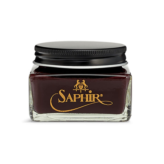 A glass jar with a black lid containing brown-colored Saphir Medaille D'Or Cordovan Cream Shoe Polish, branded with the Saphir logo on the front.