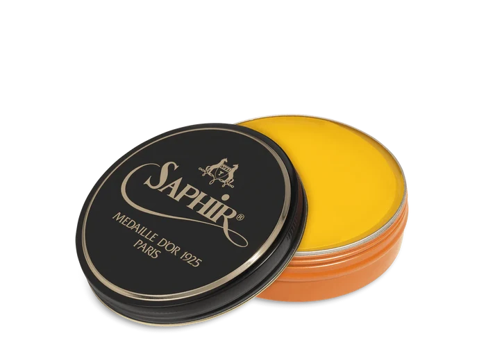 A round tin container of Saphir Medaille D'Or shoe wax polish with black lid and gold lettering.