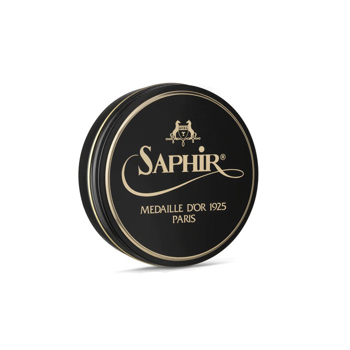 A round tin container of Saphir Medaille D'Or shoe wax polish with black lid and gold lettering.