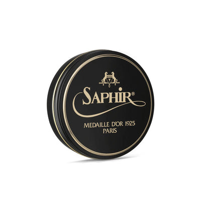 A round tin container of Saphir Medaille D'Or shoe wax polish with black lid and gold lettering.