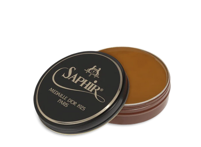 A round tin container of Saphir Medaille D'Or shoe wax polish with black lid and gold lettering.